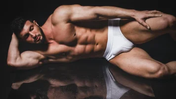 3258-athletic-hunk-in-white-briefs-on-a-mirror (1).webp