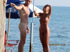 husband-with-small-shaved-cock-and-his-shaved-wife-are-pointing-at-some-guys-big-dick.webp